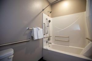 a bathroom with a bath tub and a toilet at Studio 6 North Platte - East in North Platte