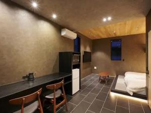 een kamer met een bed en een keuken met stoelen bij Colors Hakata 1F - Vacation STAY 90060 in Fukuoka