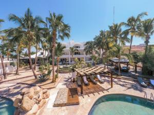 an aerial view of a resort with a pool and palm trees at Hotel & Suites El Moro in La Paz