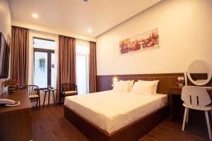 a hotel room with a bed and a window at Marina Hotel Phú Yên in Tuy Hoa