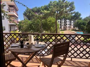 a table and chairs on a balcony with a view at Praia da Falésia - Falesia Beach - Apartment Netflix and HBO in Albufeira