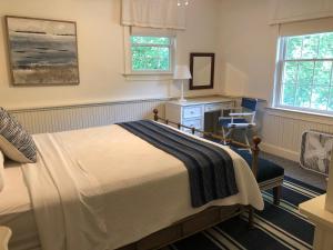 a bedroom with a bed and a desk and a chair at Chapman House in Put-in-Bay