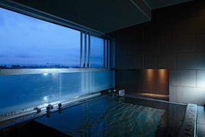 
an empty swimming pool with a view of the ocean at Bourou Noguchi Hakodate in Hakodate
