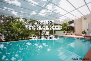 a swimming pool with the words notice pool closed for maintenance at Aava Malacca Hotel in Melaka
