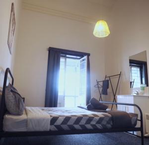 a bedroom with a bed in a room with a window at Star of the West Hotel in Port Fairy