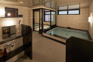 a large swimming pool in a room with at Centurion Hotel&Spa Vintage Kobe in Kobe