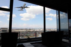 an airplane is flying over an airport at Bourou Noguchi Hakodate in Hakodate