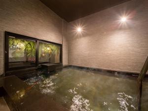 a room with a pool of water in the floor at Super Hotel Sendai Airport Inter in Natori