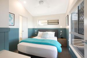 a hotel room with a bed and a window at NRMA Merimbula Beach Holiday Resort in Merimbula