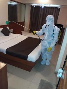 a person is washing a bed with a hose at Lucky Hotel Bandra in Mumbai