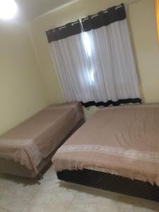 Łóżko lub łóżka w pokoju w obiekcie Casa R7