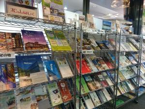 a book shelf filled with books in a store at Terminal Hotel Matsuyama in Matsuyama
