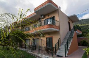 a house with a staircase in front of it at Nature & Blue in Parga