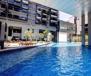 a swimming pool in the middle of a building at Imperio Residence Bathtub Studio Melacca Town-FreeParking in Melaka