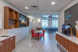 a dining area with a table and chairs in a room at Holiday Inn Express & Suites Asheville Downtown, an IHG Hotel in Asheville