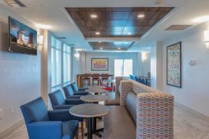 a waiting room with couches and tables and chairs at Holiday Inn Express & Suites Asheville Downtown by IHG in Asheville
