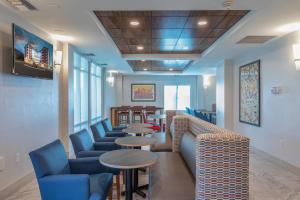 a waiting room with couches and tables and chairs at Holiday Inn Express & Suites Asheville Downtown, an IHG Hotel in Asheville