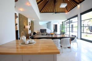 a kitchen and living room with a table and chairs at Akara Villa in Seminyak