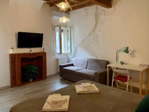 a living room with a couch and a tv at Green Rooms Ferrara in Ferrara