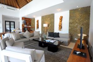 a living room with a couch and a table at Akara Villa in Seminyak