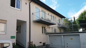 an apartment building with a garage and a balcony at Haus Edith Privathaus mit Gästezimmern in Bregenz