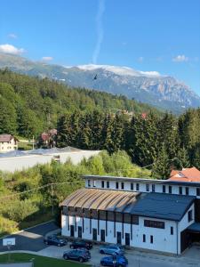 a building with cars parked in a parking lot at Lucky Number in Sinaia