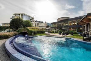 a large swimming pool in front of a building at EurothermenResort Bad Ischl - Hotel Royal 4-Sterne Superior in Bad Ischl