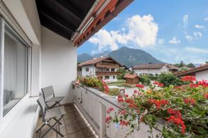 a balcony with flowers and a view of a mountain at Haus Schild in Grassau