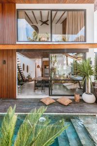 a villa with a swimming pool and a house at Beyond Bespoke Villas in Seminyak