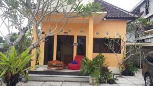 a yellow house with a red couch in front of it at Jepun Bali hotel negara in Negara