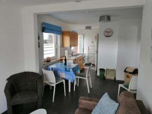 a kitchen and living room with a table and chairs at Haus Trossenstek I in Büsum