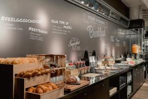 a bakery with lots of different types of bread at Ruby Coco Hotel Dusseldorf in Düsseldorf
