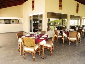 a dining room with tables and chairs in a restaurant at Resort da Ilha in Sales