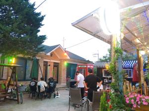a group of people standing outside of a restaurant at Jarasum Guest House in Gapyeong