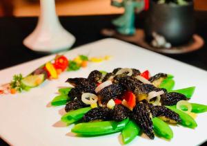 a white plate of food on a table at Crowne Plaza Kunming City Centre, an IHG Hotel in Kunming