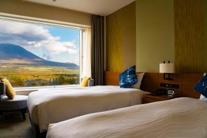 A bed or beds in a room at Shizukuishi Prince Hotel