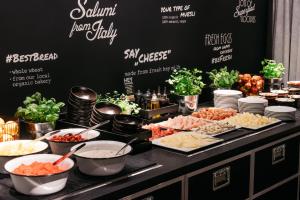 a buffet with many different types of food on a table at Ruby Leni Hotel Dusseldorf in Düsseldorf