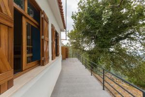 einen Balkon eines Gebäudes mit einem Baum darauf in der Unterkunft Casa do Caminheiro in Lousã