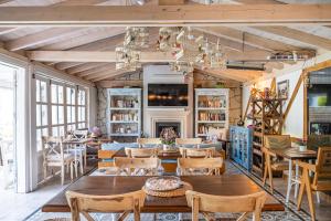 a living room with a table and chairs and a fireplace at Bay C in Alacati