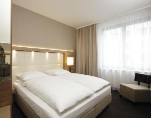 Postel nebo postele na pokoji v ubytování H4 Hotel Berlin Alexanderplatz + 29 fotografií