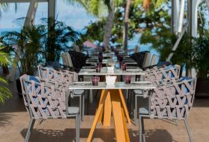 a long table with chairs and drinks on it at La Vida Samui in Chaweng