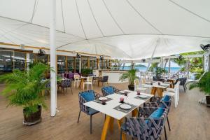 a restaurant with tables and chairs under a tent at La Vida Samui in Chaweng