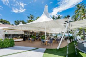 a large white tent with tables and chairs under it at La Vida Samui in Chaweng