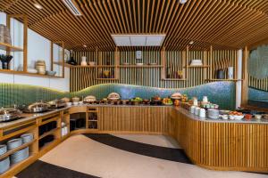 a large kitchen with wooden counters and a counter top at La Vida Samui in Chaweng