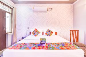 um quarto com 2 camas e uma parede em FabHotel 7 Nights Jagatpura em Jaipur