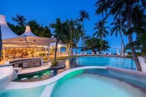 a swimming pool at a resort at night at La Vida Samui in Chaweng