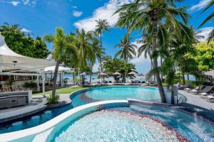 a pool at a resort with palm trees at La Vida Samui in Chaweng