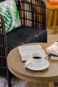 a table with a cup of coffee and a book at La Vida Samui in Chaweng