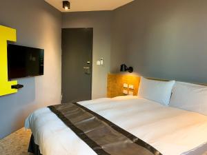 Voodi või voodid majutusasutuse Raise Hotel Taichung toas