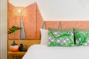 a bedroom with a bed and a chandelier at La Vida Samui in Chaweng